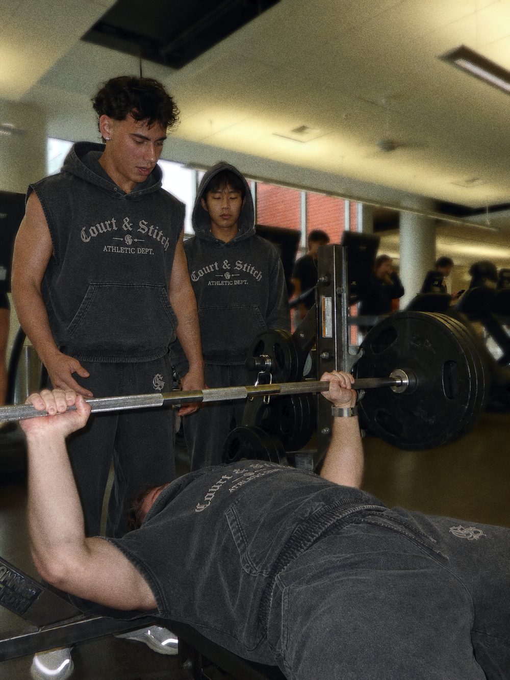 Court & Stitch sleeveless hoodies in the gym during a bench press